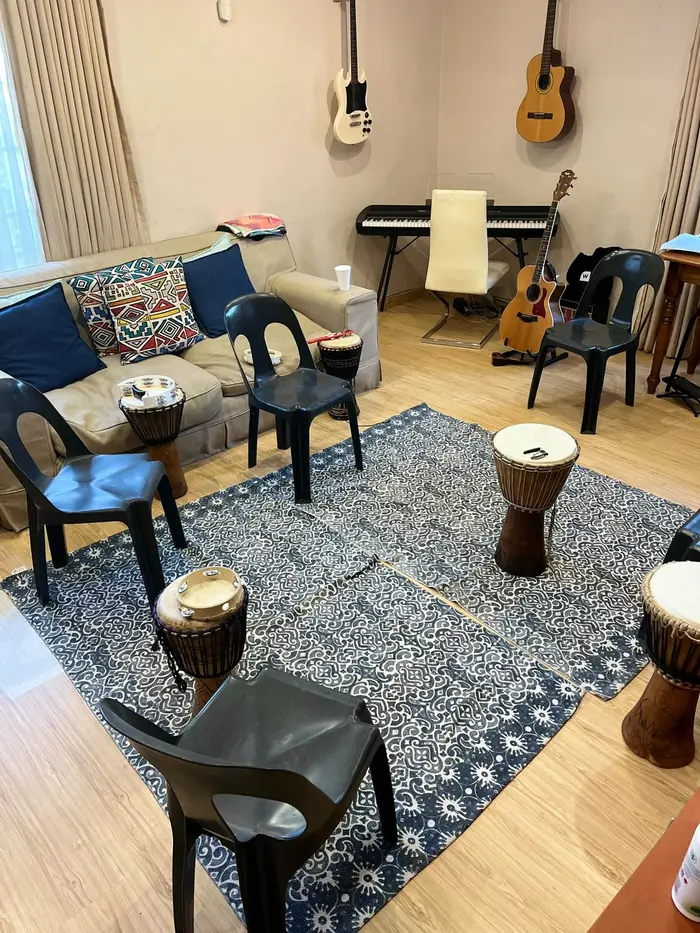 Yael's music therapy room in Johannesburg with djembes, guitars and a keyboard